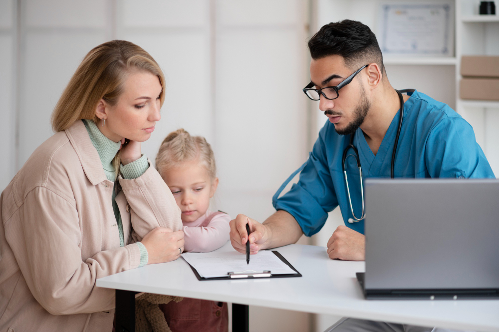 A healthcare professional discussing medicare benefits with a family.